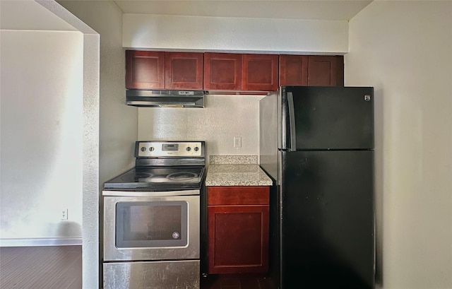 kitchen with black refrigerator and stainless steel electric range