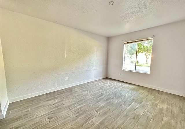 spare room with a textured ceiling