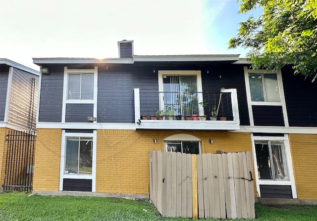 back of property with a balcony