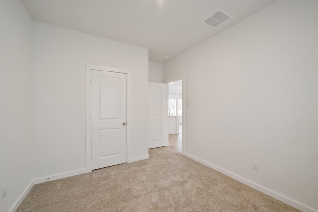 empty room featuring light carpet