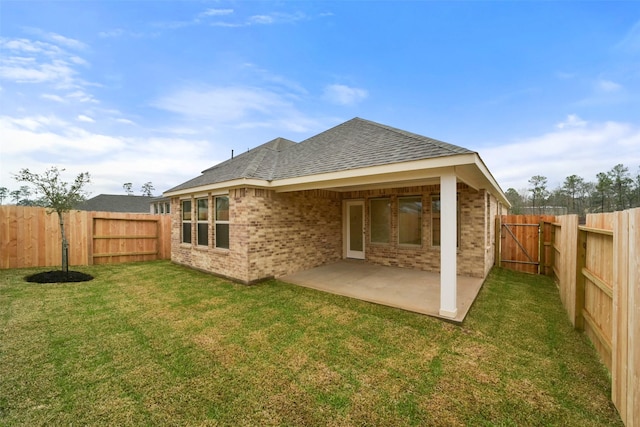 back of property featuring a patio and a lawn