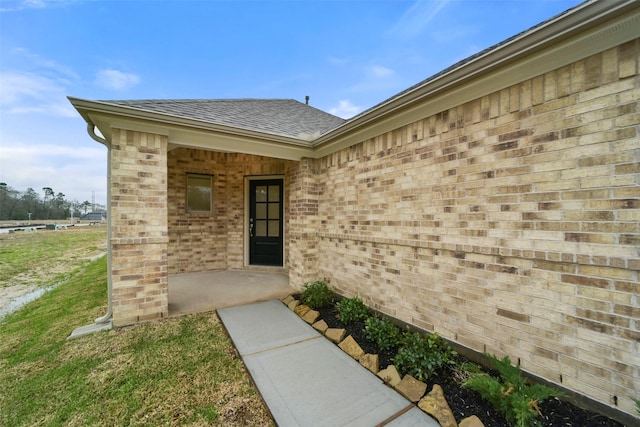 doorway to property featuring a yard and a patio area