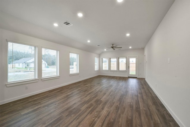 empty room with dark wood-type flooring, ceiling fan, and vaulted ceiling