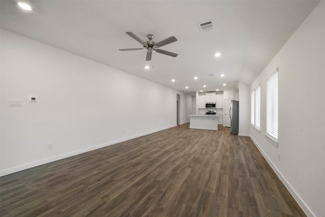 unfurnished living room with dark hardwood / wood-style floors and ceiling fan