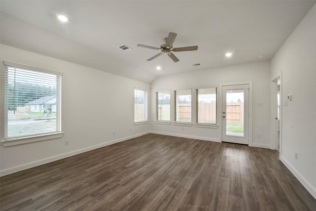 unfurnished room featuring a wealth of natural light, dark hardwood / wood-style floors, and ceiling fan