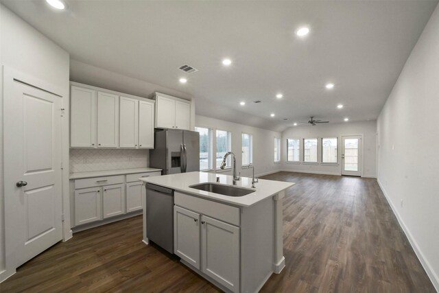 kitchen featuring an island with sink, appliances with stainless steel finishes, sink, and white cabinets