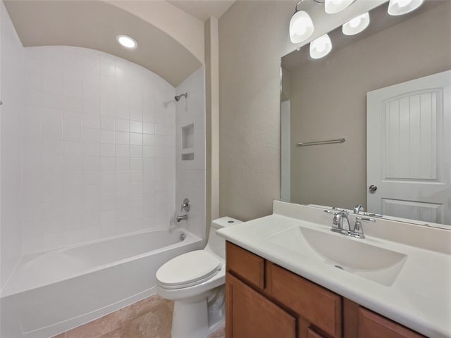 full bathroom with tile patterned flooring, vanity, toilet, and tiled shower / bath