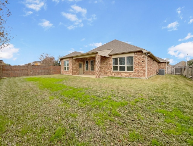 back of property featuring a lawn, cooling unit, and a patio