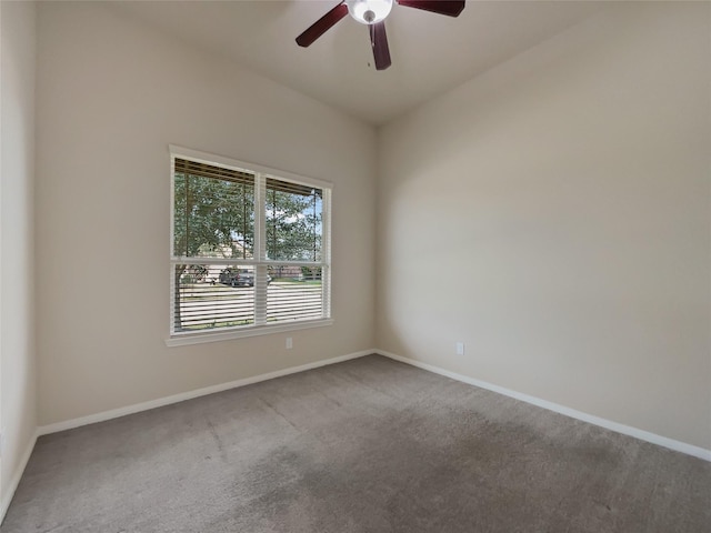 carpeted spare room featuring ceiling fan