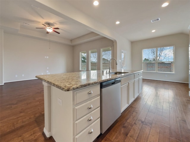 kitchen with a center island with sink, a raised ceiling, sink, stainless steel dishwasher, and dark hardwood / wood-style flooring