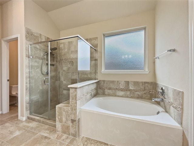 bathroom with toilet, vaulted ceiling, and independent shower and bath