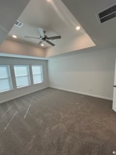 interior space featuring dark colored carpet and ceiling fan