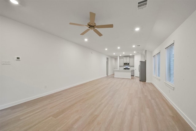 unfurnished living room with ceiling fan and light hardwood / wood-style floors