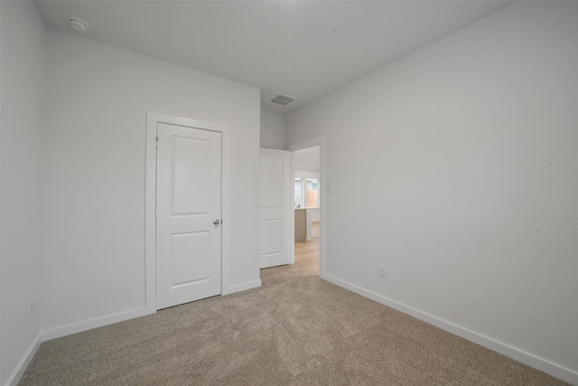 unfurnished bedroom with light carpet