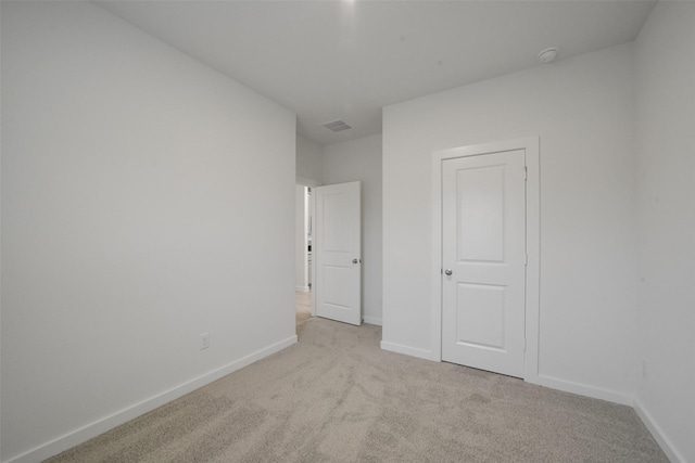 unfurnished bedroom with light colored carpet