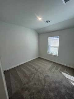 carpeted empty room with lofted ceiling