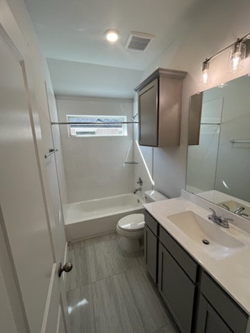 full bathroom featuring bathing tub / shower combination, vanity, and toilet