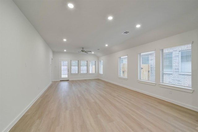 empty room with ceiling fan and light hardwood / wood-style flooring