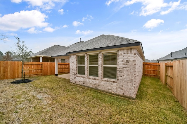 rear view of property featuring a lawn