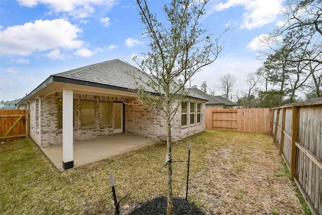 rear view of property with a patio area and a lawn