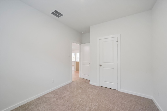 unfurnished room with light carpet