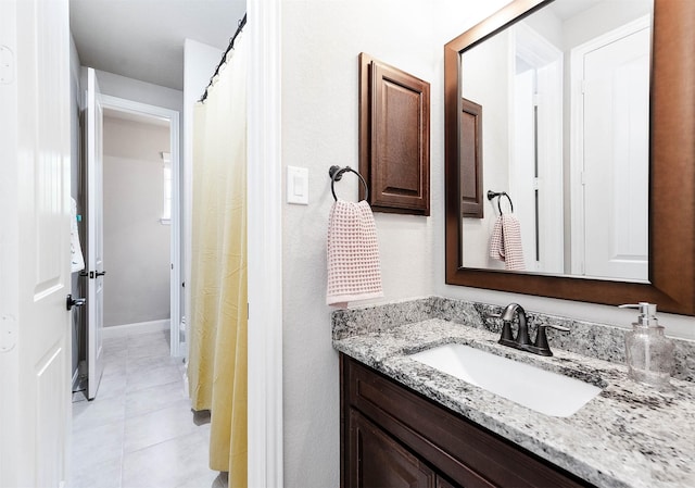 bathroom with tile patterned flooring and vanity