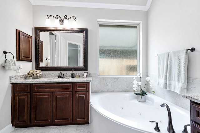 bathroom featuring a bathtub, crown molding, and vanity