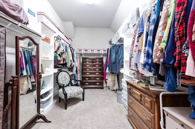 walk in closet featuring light colored carpet