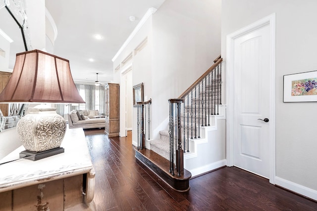 interior space with crown molding, a nursery area, and dark wood-type flooring