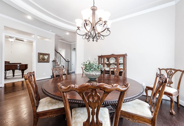 dining space with crown molding, dark hardwood / wood-style flooring, and ceiling fan with notable chandelier