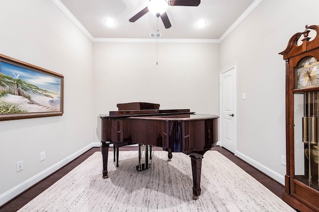 misc room featuring dark wood-type flooring, ceiling fan, and ornamental molding