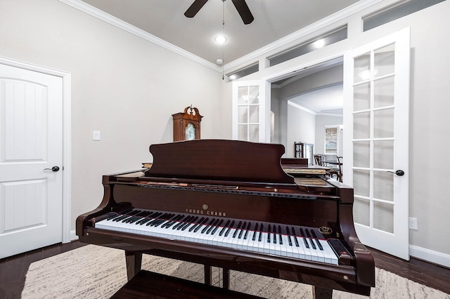 misc room with crown molding, dark hardwood / wood-style flooring, ceiling fan, and french doors