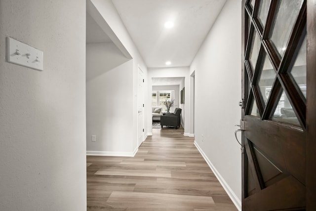 hallway with light hardwood / wood-style flooring