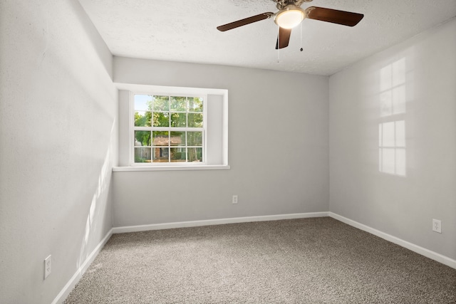 carpeted empty room featuring ceiling fan and a textured ceiling