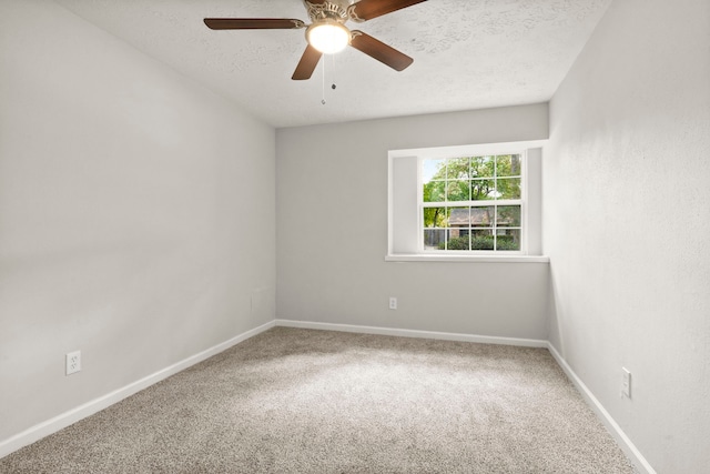 carpeted spare room with ceiling fan and a textured ceiling