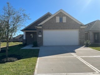 view of front of property featuring a garage and a front lawn