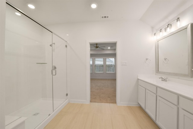 bathroom with lofted ceiling, vanity, and a shower with shower door