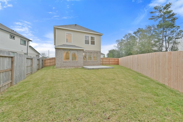 rear view of property featuring a lawn and a patio