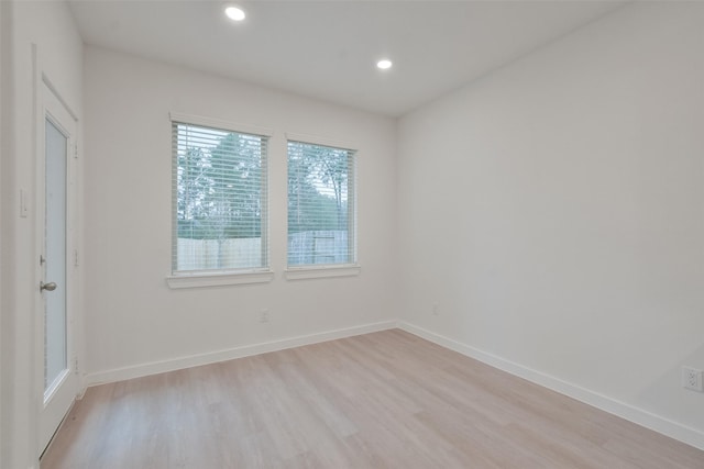 unfurnished room with light wood-type flooring