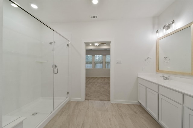 bathroom with vanity and an enclosed shower