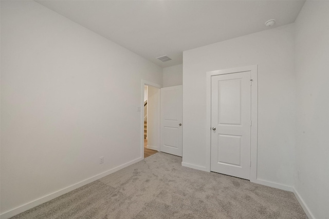 unfurnished bedroom with light colored carpet