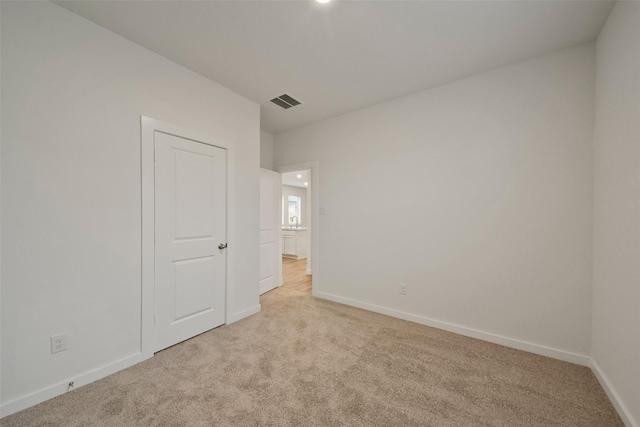 empty room featuring light colored carpet