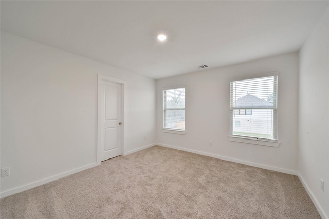 empty room with light colored carpet