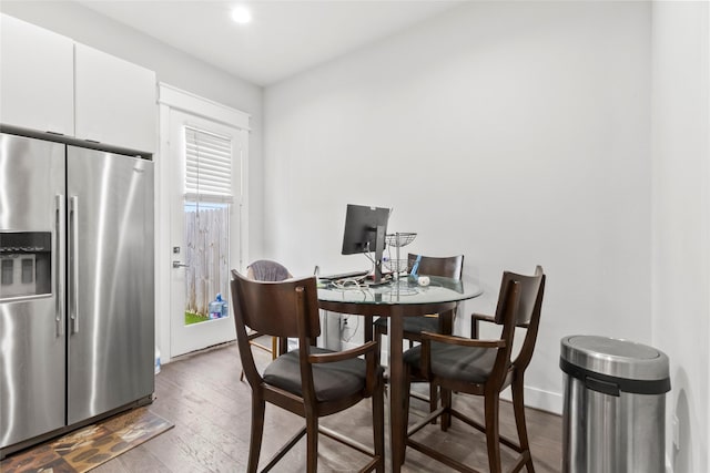 dining area with dark hardwood / wood-style flooring