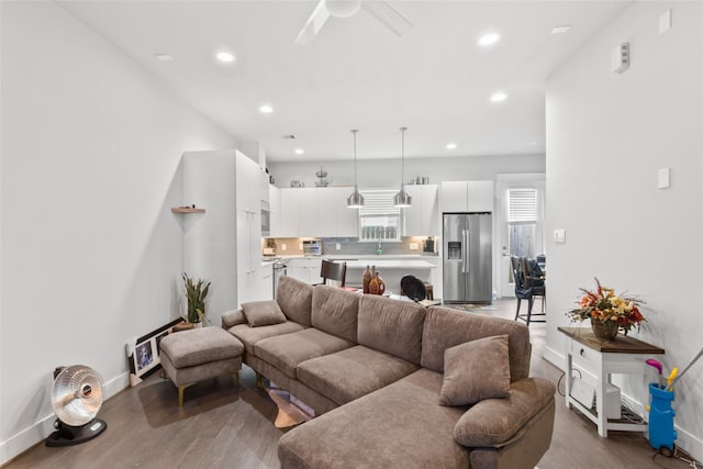 living room with ceiling fan and wood-type flooring