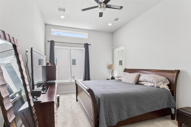 bedroom with ceiling fan and light carpet