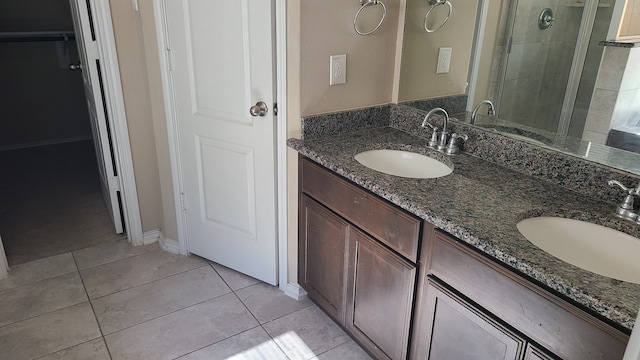 bathroom featuring tile patterned flooring, vanity, and an enclosed shower