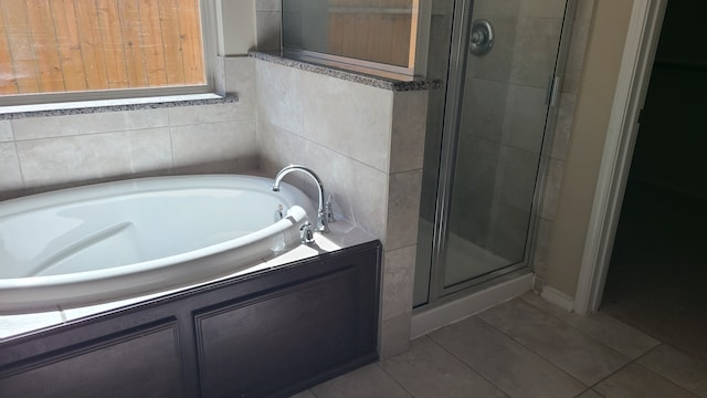 bathroom with tile patterned flooring and independent shower and bath