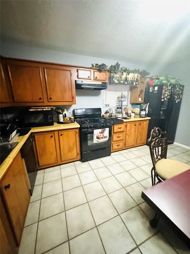 kitchen featuring light tile patterned flooring and black appliances