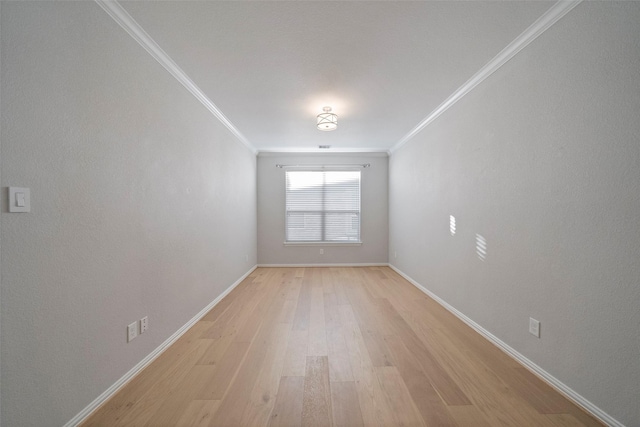 unfurnished room with light wood-type flooring and ornamental molding